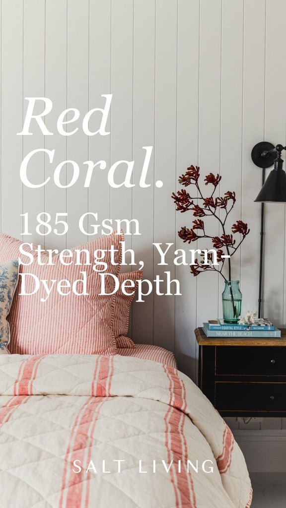 Bedding set with red coral pattern in a bedroom setting, featuring text about fabric strength and yarn dye depth.