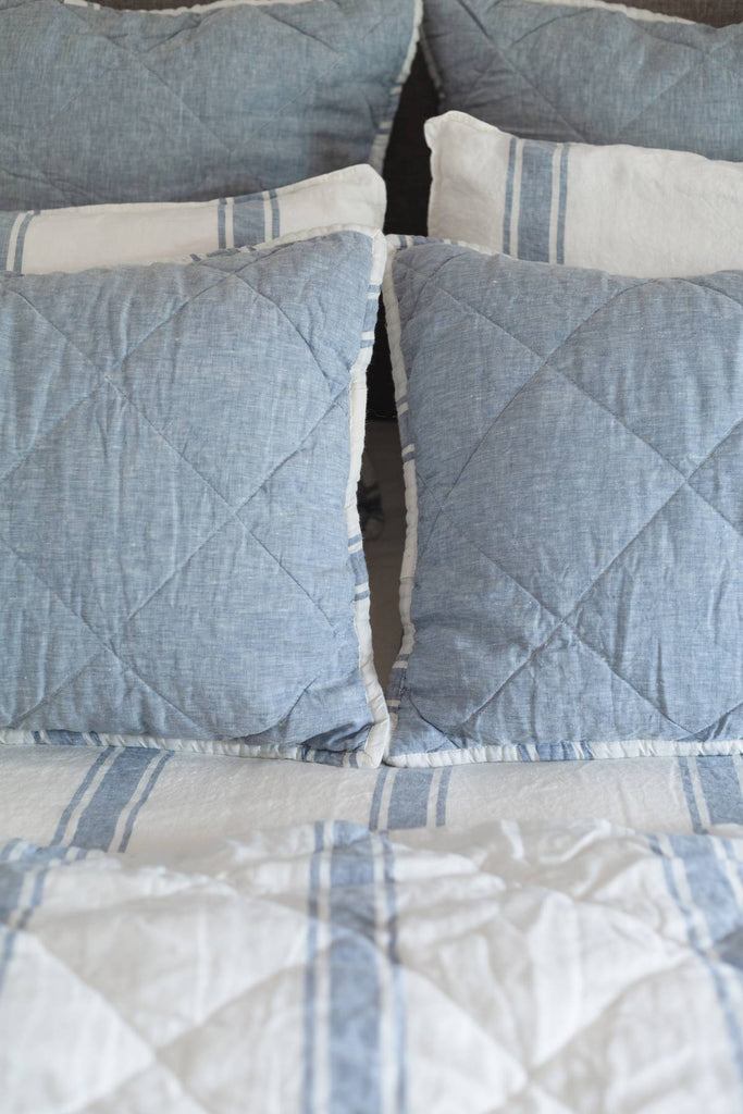 French Blue quilted shams styled on a coastal bed