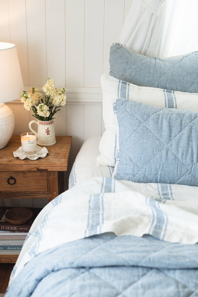 French Blue quilted shams styled on a coastal bed